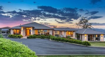 The Panorama at Tallai, a Reefsea acreage home on a landscaped block at dusk